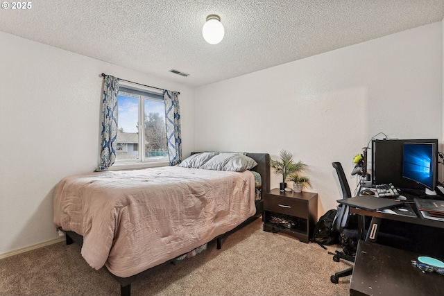 carpeted bedroom with a textured ceiling