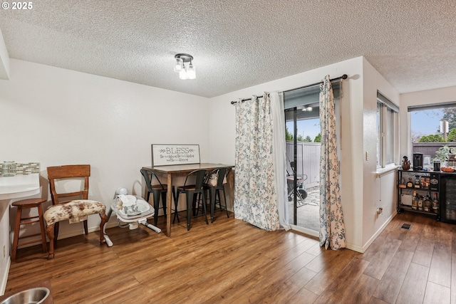 sitting room with a textured ceiling and hardwood / wood-style floors