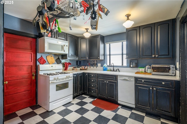 103 NW 4th St, Willamina, OR 97396 - kitchen featuring white appliances, a sink, light flooring, and light countertops
