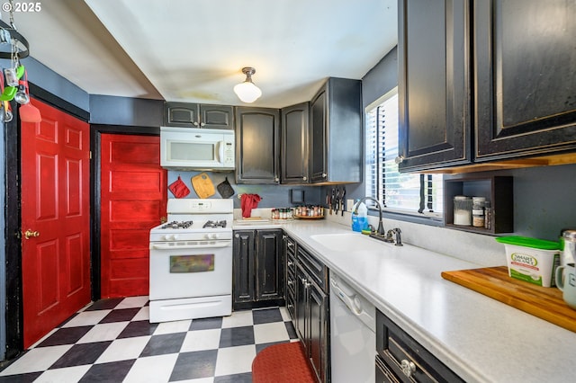 103 NW 4th St, Willamina, OR 97396 - kitchen with white appliances, a sink, tile patterned floors, and light countertops