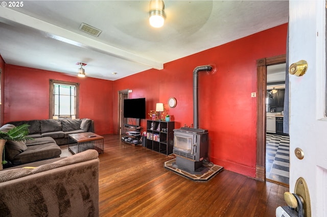 103 NW 4th St, Willamina, OR 97396 - living area featuring hardwood / wood-style flooring, a wood stove, and a ceiling fan