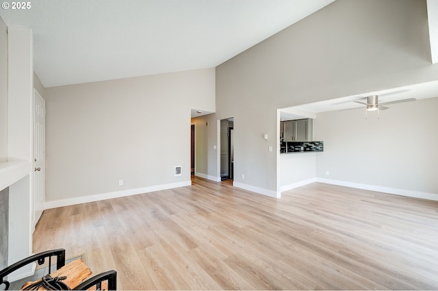 56 Galen St, Lake Oswego, OR 97035 - unfurnished living room with high vaulted ceiling, light wood finished floors, a ceiling fan, and baseboards
