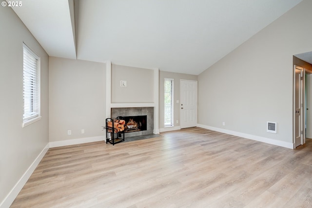 56 Galen St, Lake Oswego, OR 97035 - unfurnished living room with a tile fireplace, light wood finished floors, baseboards, and vaulted ceiling