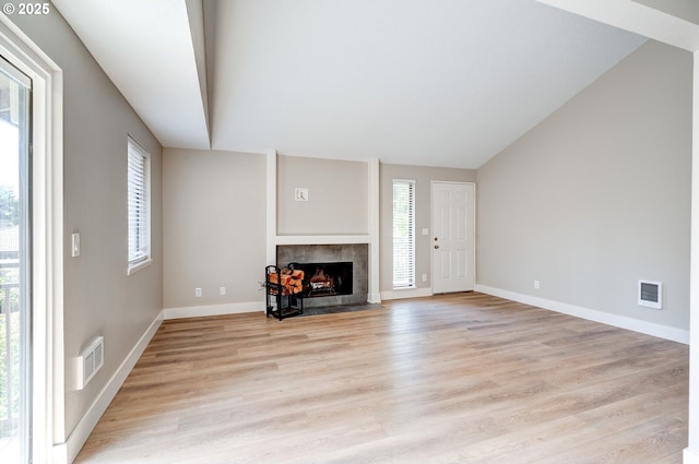 56 Galen St, Lake Oswego, OR 97035 - unfurnished living room with a tiled fireplace, light wood-style floors, and baseboards