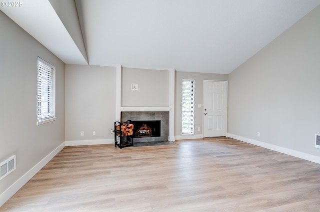 56 Galen St, Lake Oswego, OR 97035 - unfurnished living room featuring a fireplace, light wood-style flooring, baseboards, and vaulted ceiling