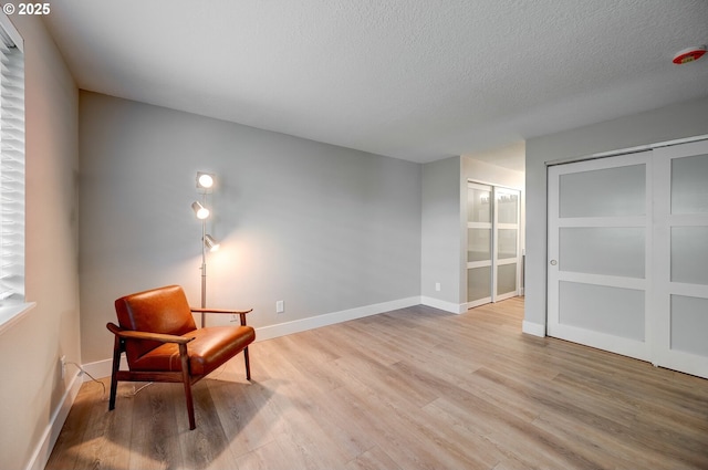 56 Galen St, Lake Oswego, OR 97035 - sitting room with light wood-style floors, baseboards, and a textured ceiling