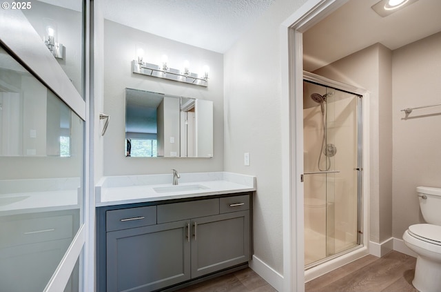 56 Galen St, Lake Oswego, OR 97035 - full bath with toilet, wood finished floors, a stall shower, vanity, and baseboards
