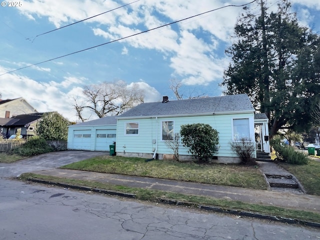 ranch-style home with a garage and aphalt driveway