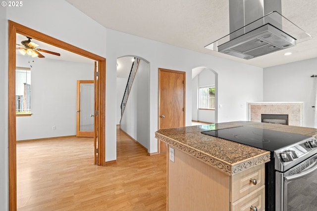 651 NE Anderson Rd, Gresham, OR 97030 - kitchen with stainless steel electric range, tile countertops, arched walkways, and a ceiling fan