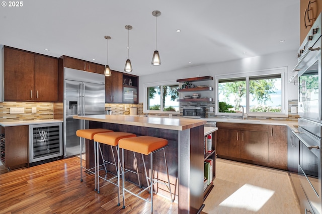 34926 SW Johnson School Rd, Cornelius, OR 97113 - kitchen with wine cooler, open shelves, appliances with stainless steel finishes, decorative backsplash, and recessed lighting