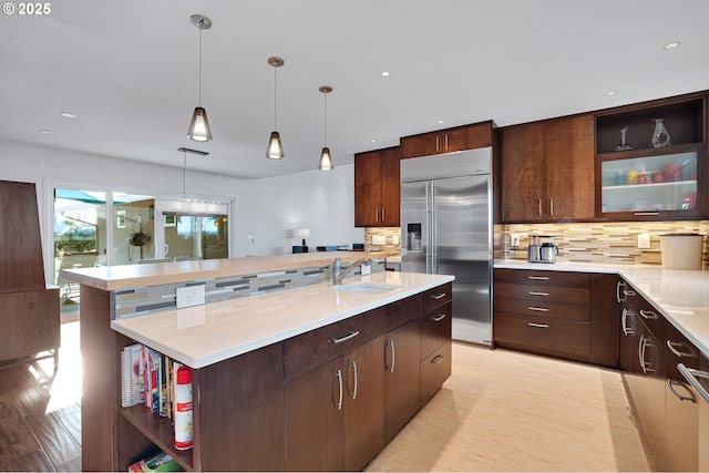 34926 SW Johnson School Rd, Cornelius, OR 97113 - kitchen featuring built in refrigerator, open shelves, backsplash, light countertops, and an island with sink