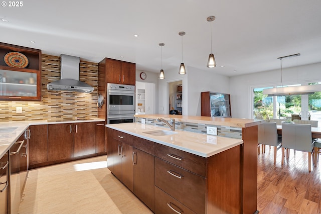 34926 SW Johnson School Rd, Cornelius, OR 97113 - kitchen featuring island range hood, stainless steel double oven, a kitchen island with sink, tasteful backsplash, and pendant lighting