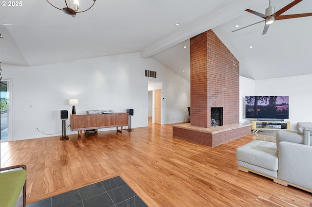 34926 SW Johnson School Rd, Cornelius, OR 97113 - living area with high vaulted ceiling, beamed ceiling, ceiling fan, a fireplace, and wood finished floors