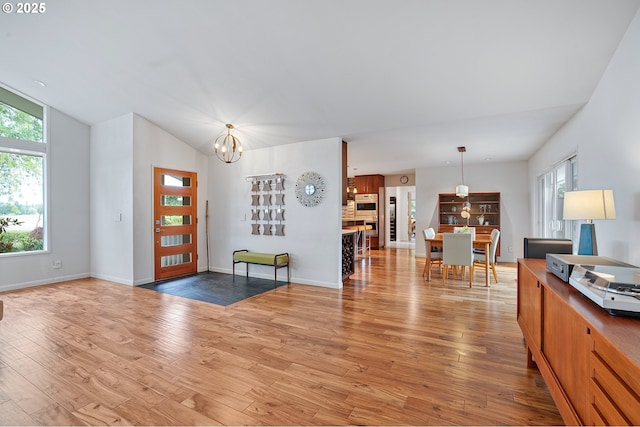 34926 SW Johnson School Rd, Cornelius, OR 97113 - living area with a chandelier, light wood-type flooring, and vaulted ceiling