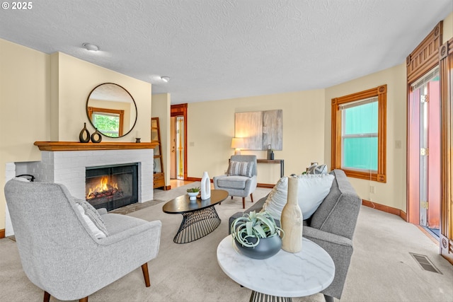 3147 SE Belmont St, Portland, OR 97214 - living area with a fireplace, light carpet, and a textured ceiling