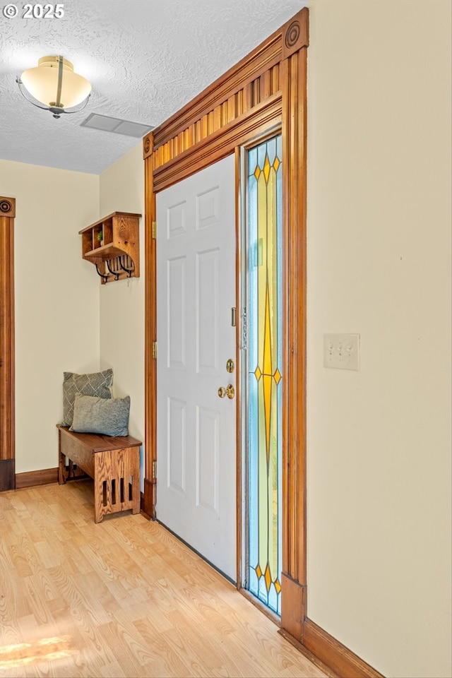 3147 SE Belmont St, Portland, OR 97214 - foyer featuring light wood finished floors and a textured ceiling
