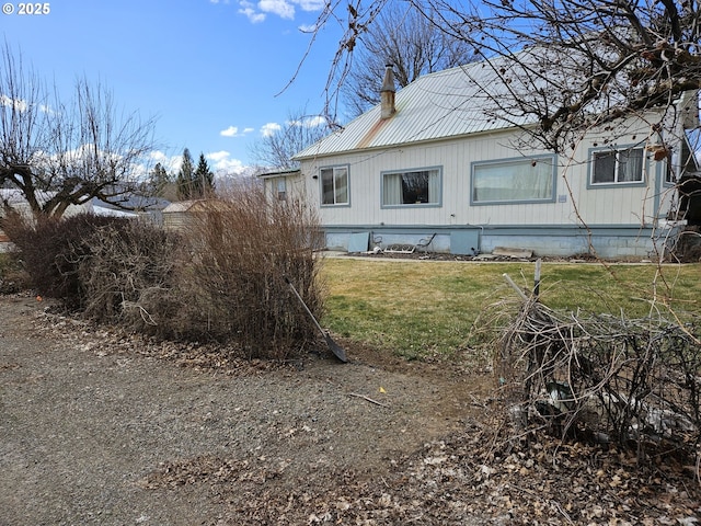 333 3rd St, Richland, OR 97870 - view of side of property featuring metal roof, a yard, and a chimney