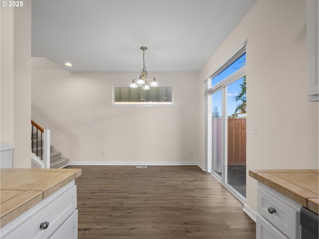 dining room featuring dark hardwood / wood-style floors and an inviting chandelier