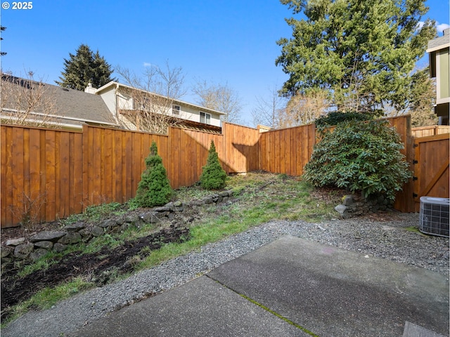 view of yard featuring central AC and a patio area