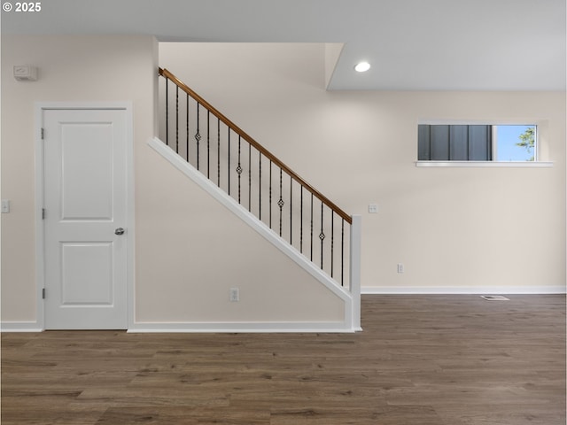 stairs with wood-type flooring