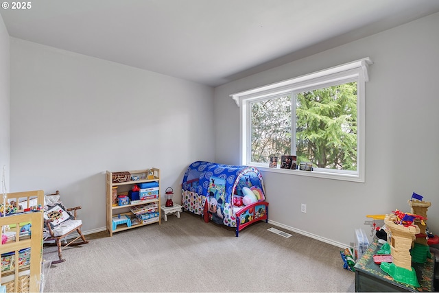 carpeted bedroom with visible vents and baseboards