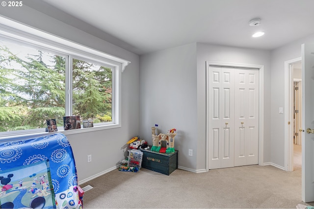 bedroom with a closet, visible vents, baseboards, and carpet
