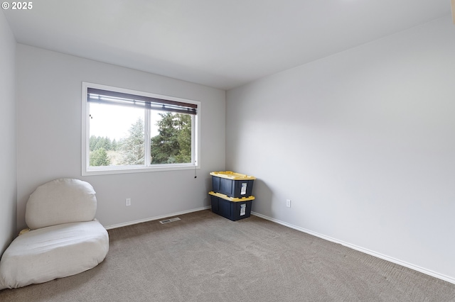 living area featuring visible vents, baseboards, and carpet floors