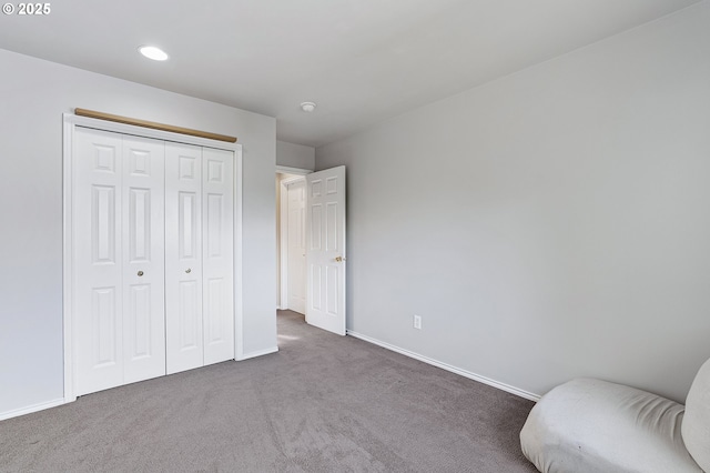 unfurnished bedroom with a closet, baseboards, and carpet
