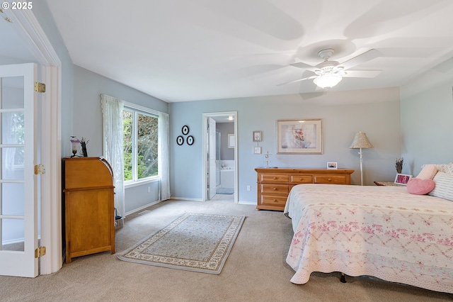 bedroom featuring carpet, baseboards, a ceiling fan, and connected bathroom