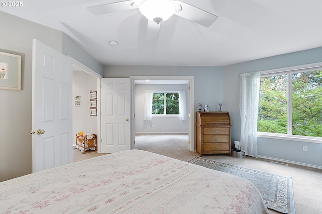 carpeted bedroom featuring baseboards and a ceiling fan