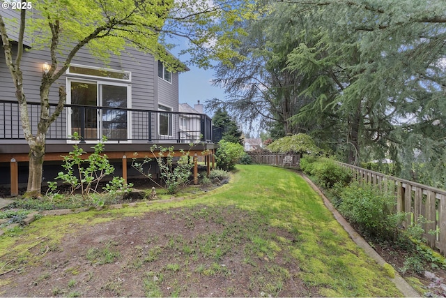 view of yard with fence private yard and a wooden deck