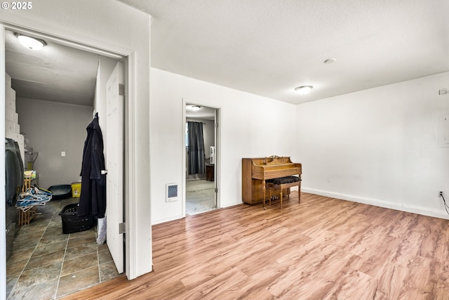 9304 NE 96th St, Vancouver, WA 98662 - spare room with wood finished floors, heating unit, and a textured ceiling
