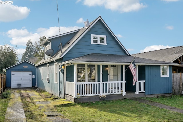 view of front of property featuring an outbuilding, a porch, a garage, and a front lawn