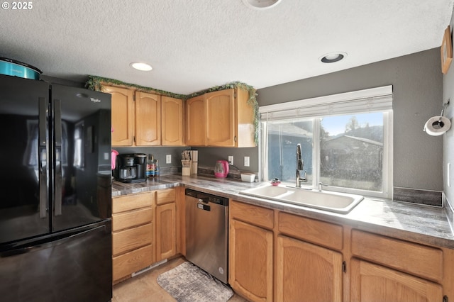 kitchen featuring light tile patterned flooring, black refrigerator, sink, stainless steel dishwasher, and a textured ceiling