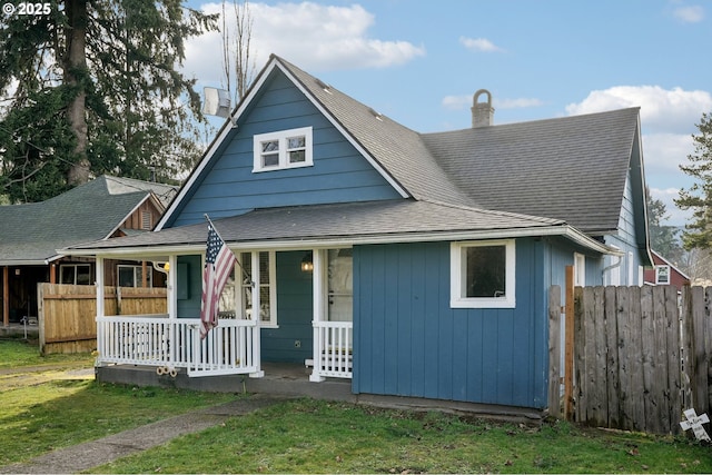 view of front of home with a front yard and covered porch