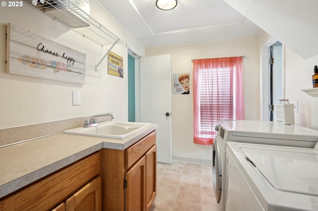 laundry area featuring independent washer and dryer and sink