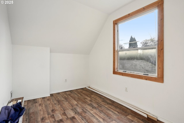 additional living space with hardwood / wood-style flooring and vaulted ceiling