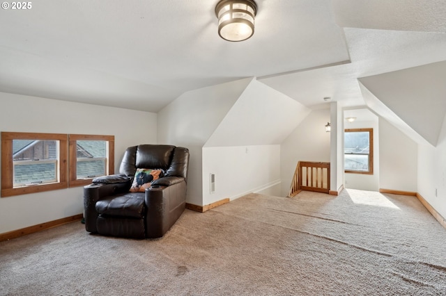 bonus room with lofted ceiling, a healthy amount of sunlight, and light colored carpet