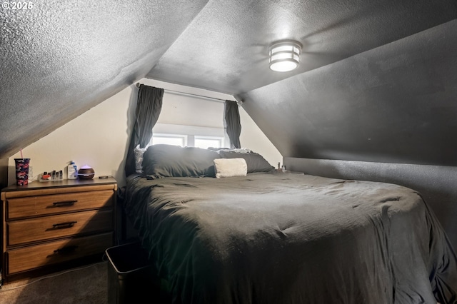 bedroom featuring vaulted ceiling and a textured ceiling