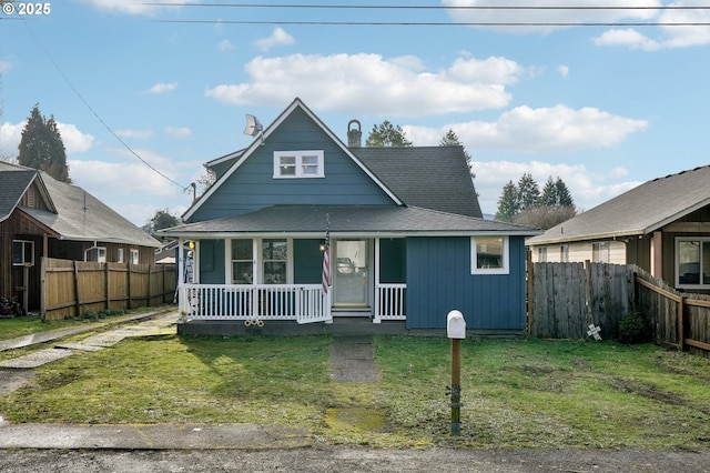 bungalow-style house with covered porch and a front lawn