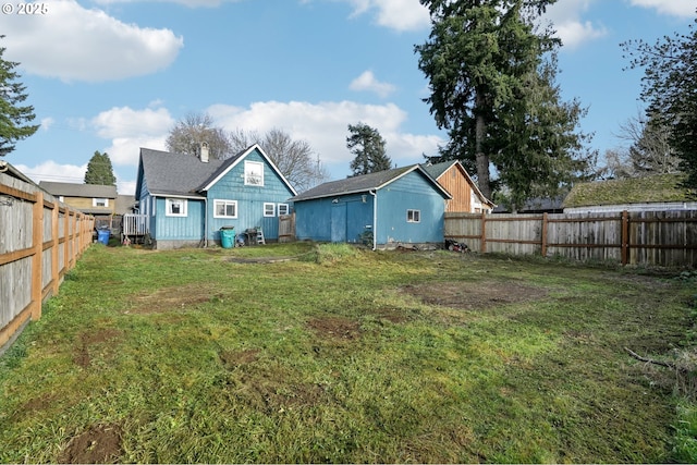 rear view of property featuring a yard