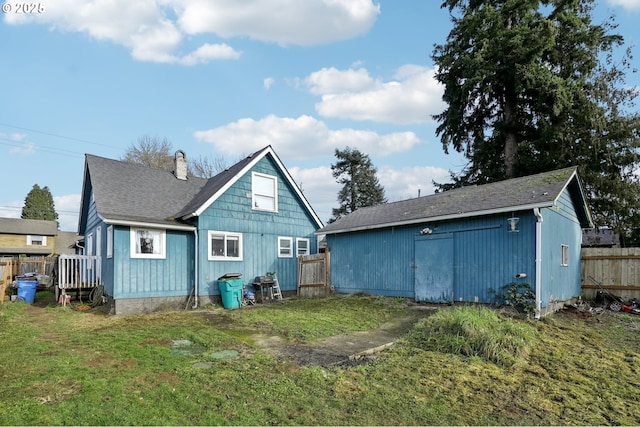 rear view of house featuring a lawn