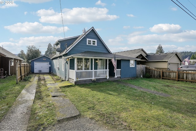 bungalow-style house featuring an outbuilding, a garage, a front lawn, and covered porch