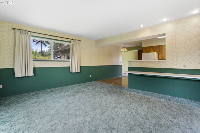 empty room with wainscoting, carpet floors, wallpapered walls, and recessed lighting