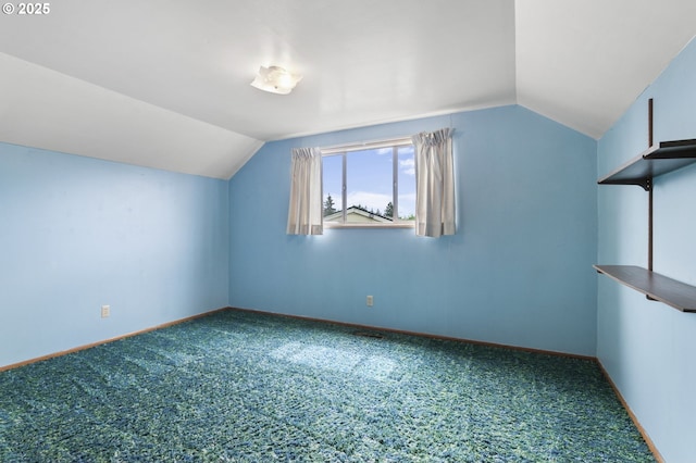 additional living space with vaulted ceiling, carpet, and baseboards