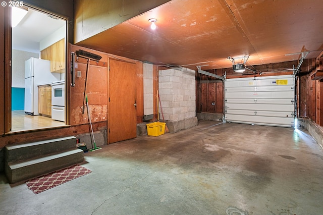garage with a garage door opener and freestanding refrigerator