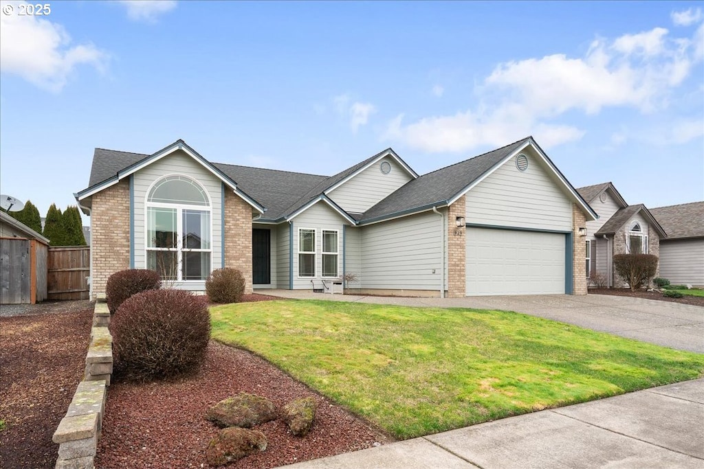 ranch-style house with a garage and a front yard