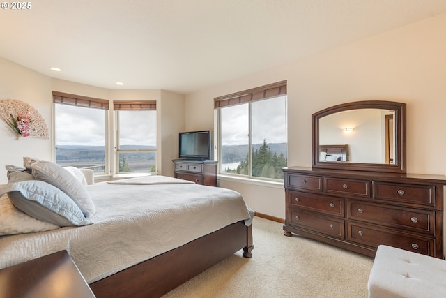 bedroom with light carpet, recessed lighting, and baseboards