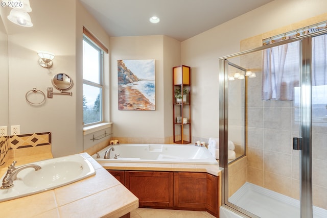 bathroom with tile patterned floors, a sink, a bath, and a shower stall