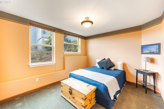 bedroom featuring a textured ceiling, carpet floors, and baseboards